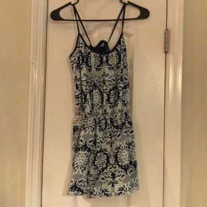A blue and white designed romper with open back